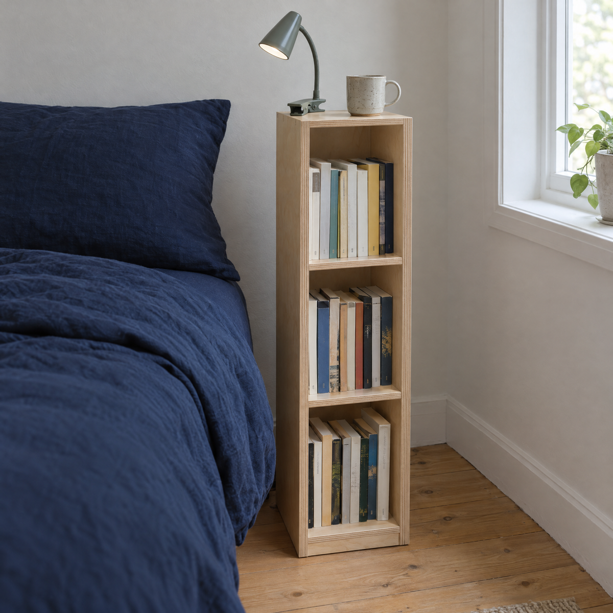 Book Tower beside a bed