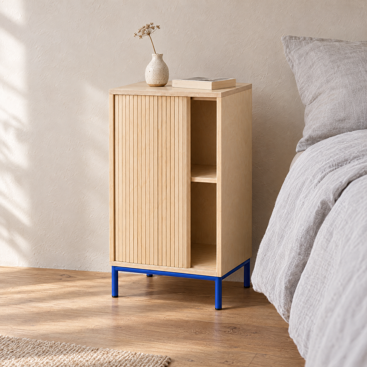 Tambour Cabinet beside a bed